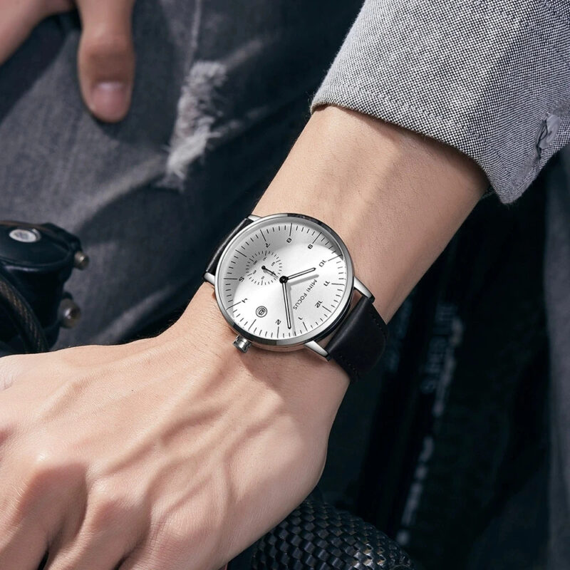 The Mini Focus MF0303G is a stylish men’s analog wristwatch designed for daily elegance and functionality. Featuring a clean, silver-toned dial and a classic leather strap, this timepiece captures a refined yet understated look. It runs on a reliable quartz movement and offers 30 m (3 ATM) water resistance, making it suitable for everyday wear — from office settings to casual evenings.